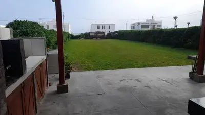 a view of a yard with a large lawn at Casa frente al mar in Lurín