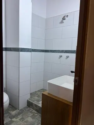 a white bathroom with a tub and a toilet at Lavanda lodge Ollantaytambo in Ollantaytambo