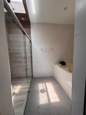 a bathroom with a shower and a bath tub at Villa Luquin in Hacienda Santo Domingo