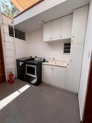 a small kitchen with a stove and a sink at Villa Luquin in Hacienda Santo Domingo