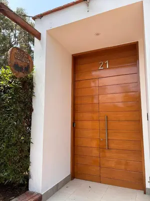 a wooden garage door with the number on it at Villa Luquin in Hacienda Santo Domingo