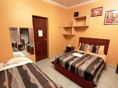 a bedroom with two beds in a room at Hostal GQ in Lima