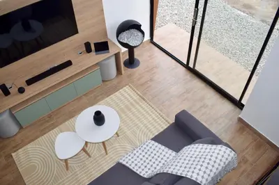 a living room with a couch and a table at Tiny House con Jacuzzi, Fogata y Starlink in Anta