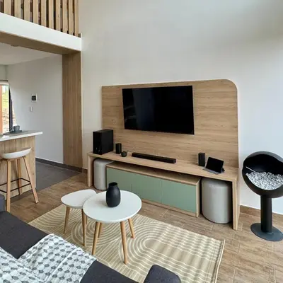 a living room with a flat screen tv on a wall at Tiny House con Jacuzzi, Fogata y Starlink in Anta