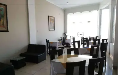 a dining room with tables and chairs and a window at Hotel Cerro Azul in La Merced