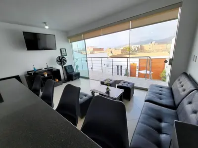 a living room with a table and chairs and a large window at Casa Bujama Playa y Piscina Privada in Bujama Baja