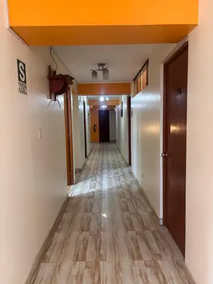a corridor of an office building with a long hallway at Hospedaje Don Luciano in San Vicente de Cañete