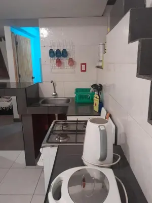 a small kitchen with a sink and a white appliance at Minidepa San Bartolo in San Bartolo
