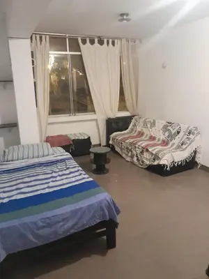 a bedroom with two beds and a window at Minidepa San Bartolo in San Bartolo