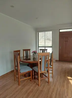 a dining room with a table and chairs and a window at Casa de Campo en Santa Rosa de Quivez in Santa Rosa de Quives