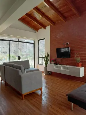 a living room with a couch and a flat screen tv at Casa de Campo en Santa Rosa de Quivez in Santa Rosa de Quives