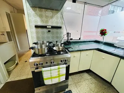 a kitchen with a stove with pots and pans on it at Miraflores kennedy view in Lima