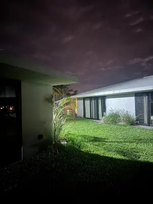 a house with a lawn in front of a building at Beautiful house with pool in Oasis Bahía de Paracas in Las Palmeras