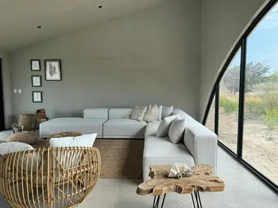 a living room with a couch and a table at Beautiful house with pool in Oasis Bahía de Paracas in Las Palmeras