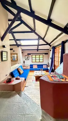 a living room with a blue couch in a room at Casa Munay in Urubamba