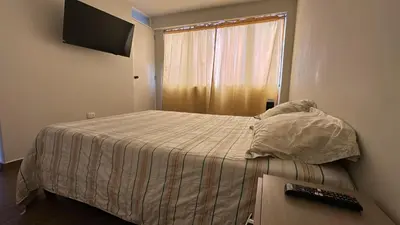 a bedroom with a bed and a window with a keyboard at Mn Depa en San Bartolo in San Bartolo