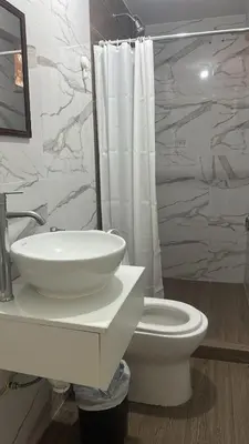 a white bathroom with a sink and a toilet at Mn Depa en San Bartolo in San Bartolo
