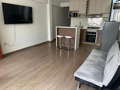 a living room with a couch and a kitchen at Mn Depa en San Bartolo in San Bartolo