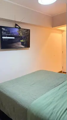 a bedroom with a bed with a television on the wall at Apartment in Lima close to everything in Lima