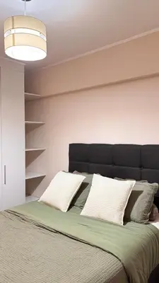 a bed with a black headboard and white pillows at Apartment in Lima close to everything in Lima