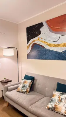a living room with a couch and a painting at Apartment in Lima close to everything in Lima