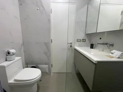 a white bathroom with a toilet and a sink at The Modern Studios by Vibrant in Lima