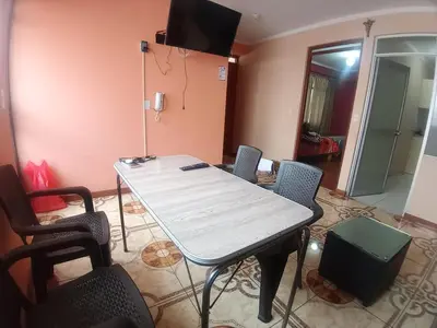 a room with a table with chairs and a television at Casa Hospedaje Minidepa Piquichas in Abancay