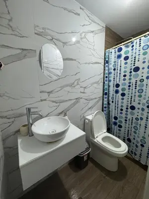 a bathroom with a white sink and a toilet at Moderno Mn Depa en San Bartolo in San Bartolo