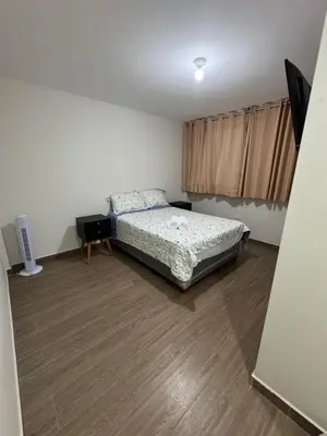 a bedroom with a bed and a wooden floor at Moderno Mn Depa en San Bartolo in San Bartolo
