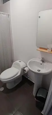a bathroom with a white toilet and a sink at Casa en condominio en Paracas, a 7 min del Chaco in Puerto Nuevo