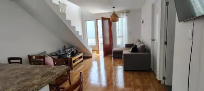 a living room with a couch and a table at Casa en condominio en Paracas, a 7 min del Chaco in Puerto Nuevo