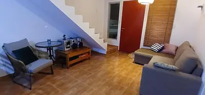 a living room with a couch and a table at Casa en condominio en Paracas, a 7 min del Chaco in Puerto Nuevo