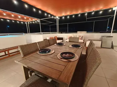 a wooden table with chairs and a dining room at Casa de Playa en Puerto Viejo, Condominio Kalua in San Antonio