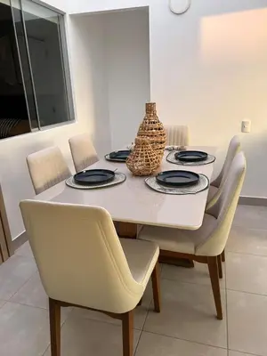a dining room table with chairs and a vase on it at Casa de Playa en Puerto Viejo, Condominio Kalua in San Antonio