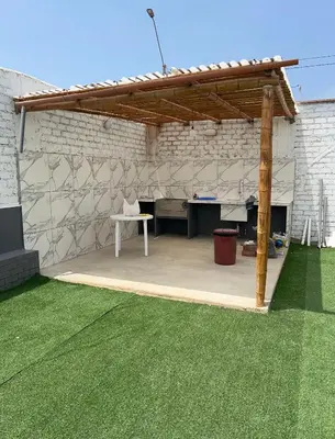 a pavilion with a desk and a table in a yard at Departamento 201 in Punta Negra