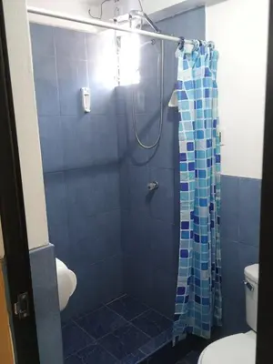 a bathroom with a shower with a shower curtain at Refugio del Caminante in Ollantaytambo