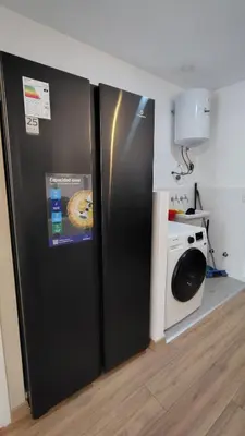 a black refrigerator in a kitchen next to a microwave at Vital Building - Modern Apartment Miraflores in Lima