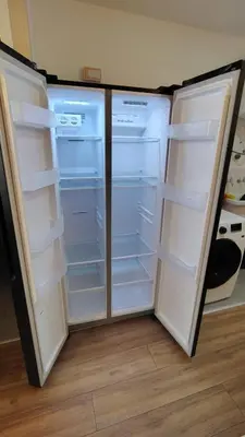 a refrigerator with its doors open in a kitchen at Vital Building - Modern Apartment Miraflores in Lima