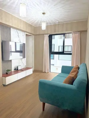 a living room with a blue couch and a large window at Vital Building - Modern Apartment Miraflores in Lima