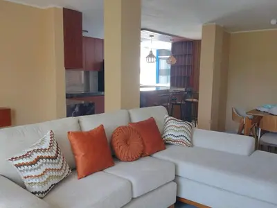 a living room with a couch with pillows on it at Casa Quevedo in Ica
