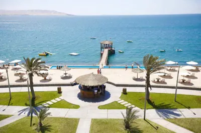 a view of a resort with a pier and the ocean at Departamento con Vista al Mar - Paracas - Condominio Nautico Las Velas in Paracas