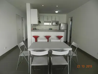 a kitchen with a table and chairs in a room at Departamento con Vista al Mar - Paracas - Condominio Nautico Las Velas in Paracas