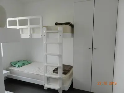 a white bunk bed with a ladder in a room at Departamento con Vista al Mar - Paracas - Condominio Nautico Las Velas in Paracas