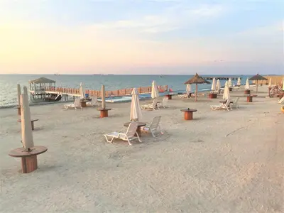 a group of chairs and umbrellas on the beach at Departamento con Vista al Mar - Paracas - Condominio Nautico Las Velas in Paracas