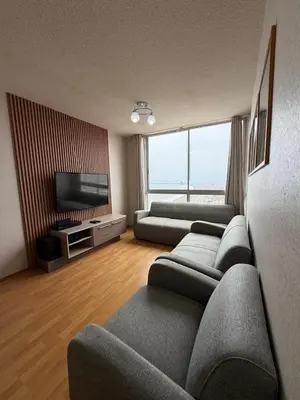 a living room with couches and a flat screen tv at Costanera Uno Vista al Mar in Lima