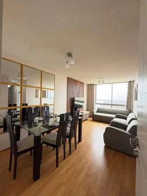 a living room with a table and chairs and a couch at Costanera Uno Vista al Mar in Lima