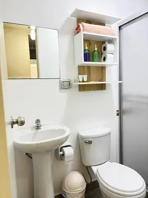 a bathroom with a toilet and a sink and a mirror at Costanera Uno Vista al Mar in Lima