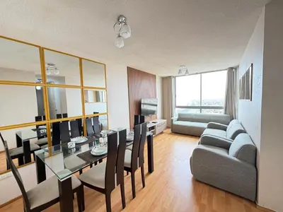 a living room with a table and a couch at Costanera Uno Vista al Mar in Lima