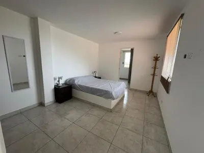 a bedroom with a bed and a tiled floor at Amplia casa petfriendly con parrilla cerca a Asia in Salitre