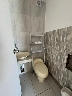 a bathroom with a toilet and a sink at Amplia casa petfriendly con parrilla cerca a Asia in Salitre